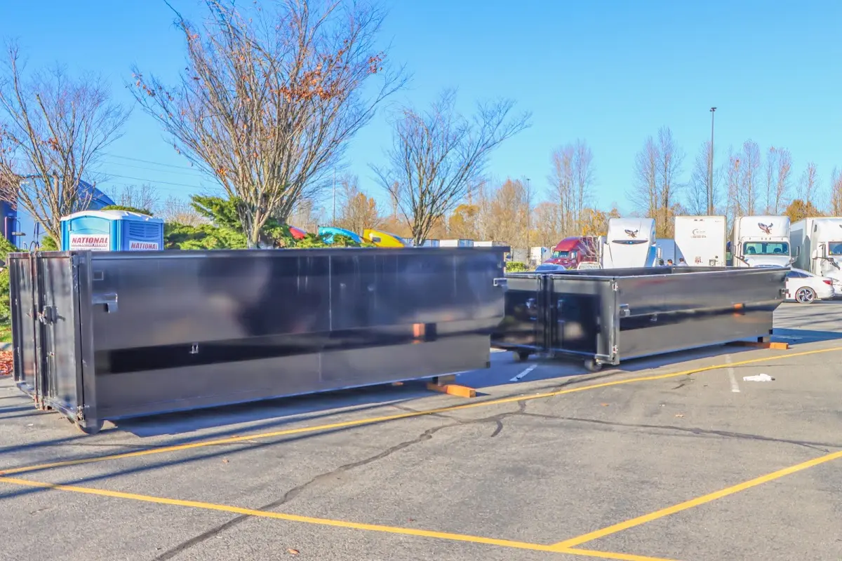 Professional dumpster rental service with roll-off container on residential driveway in Skowhegan